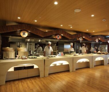 Buffet counter with chefs and wooden interior at Heiseikan Shiosaitei, Hokkaidō