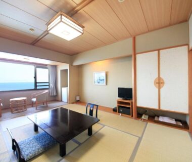 Bright tatami room with low table, window seating and sliding fusuma at Heiseikan Shiosaitei in Hokkaidō