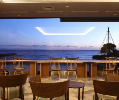 Seaside lounge with wooden chairs facing window, Heiseikan Shiosaitei Hanatsuki, Hokkaidō
