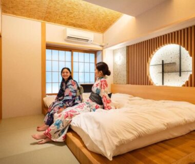Two women in yukata on futon in tatami room at Hibikino, Gunma