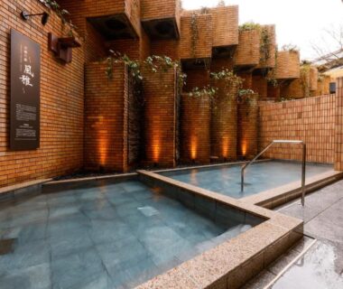 Brick-walled outdoor onsen baths with handrail at Hida Takayama Onsen Takayama Green Hotel, Gifu