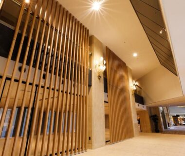 Spacious lobby with vertical wooden slats and high ceiling at Hida Takayama Onsen Takayama Green Hotel, Gifu