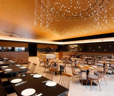 Spacious dining hall with chandelier and wooden chairs at Hida Takayama Onsen Takayama Green Hotel in Gifu
