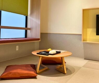 Low table and cushions on tatami near window in ryokan room at Hidamari Ichinoyu, Kanagawa