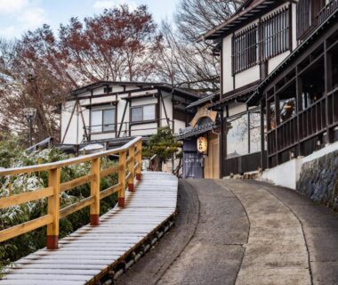 Sloping wooden path and traditional ryokan facades at Hidatakayama Futarishizuka Hakuun in Gifu, Chūbu, Japan