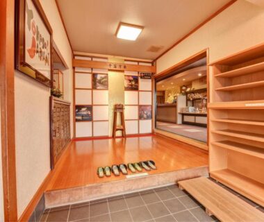 Traditional genkan with lined slippers, wooden flooring and shoe shelf at Hidatakayama Futarishizuka Hakuun, Gifu, Chūbu