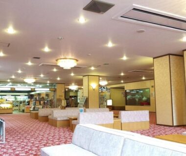 Carpeted lobby seating with chandeliers and reception at Higashiyama Park Hotel Shinfugetsu, Fukushima