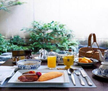 Japanese breakfast set on low table with grilled fish, rice bowls and tea, Hiiragiya Kyoto