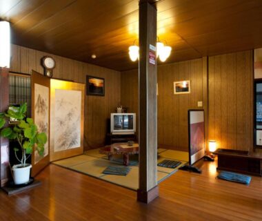 Tatami lounge with low table, shoji screens and wooden flooring at Hinode Ryokan in Mie, Kansai