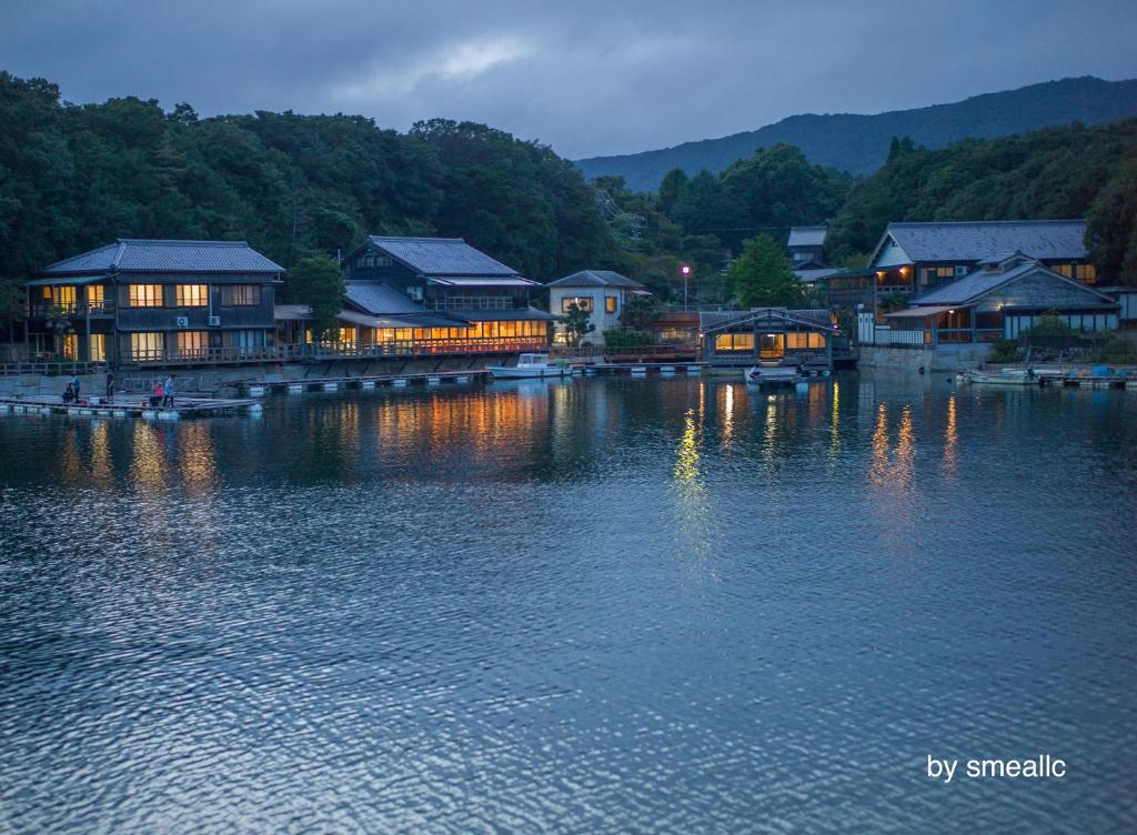Lakeside ryokan waterfront at Hiogiso Mie Evening lights reflecting on lake in front of Hiogiso ryokan in Mie, Kansai with wooden waterfront buildings