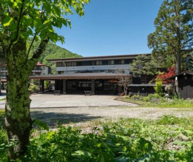 Front courtyard and main building of Hirayukan surrounded by trees in Gifu, Chūbu, Japan