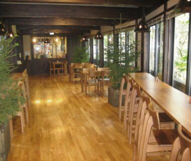 Long wooden dining corridor with tables and chairs at Hirayunomori in Gifu, Chubu, Japan