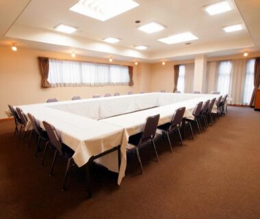 U-shaped meeting setup with chairs and white tablecloths at Hirugami Grand Hotel Tenshin in Nagano