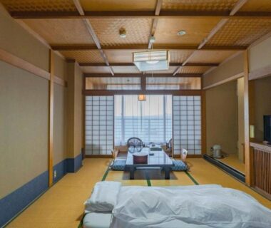Tatami room with futon, low table and shoji screens at Hokkawa Onsen Hotel in Shizuoka, Chūbu