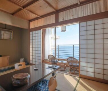 Tatami room with shoji screens, low table and balcony overlooking the sea at Hokkawa Onsen Hotel Shizuoka