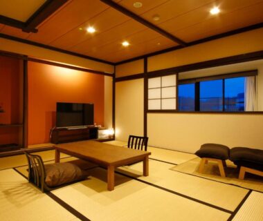 Traditional tatami room with low wooden table, zabuton cushions, shoji screens and seating at Hokuriku Yamashiro Onsen Hotel Kikyou, Ishikawa