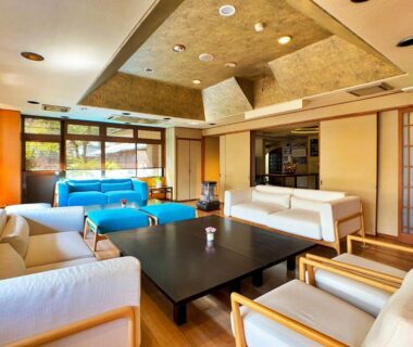 Bright lounge with sofas, low table and shoji screens at Honjin, Shizuoka, Chūbu, Japan