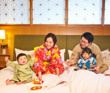 Family in yukata on futon beds in shoji-screened ryokan room at Honjin Hiranoya Kachoan, Gifu