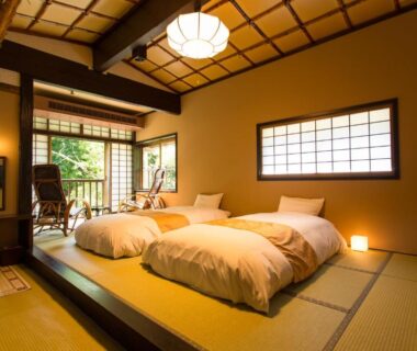 Tatami room with futon beds, shoji screens and garden view at Honke Bankyu, Tochigi, Kantō