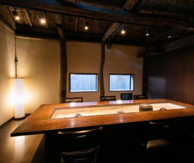 Intimate wooden dining room with recessed table at Honke Bankyu in Tochigi, Kantō, Japan