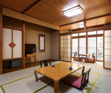 Traditional tatami room with low table, zabuton cushions and shoji screens at Horohoro Sanso in Hokkaidō