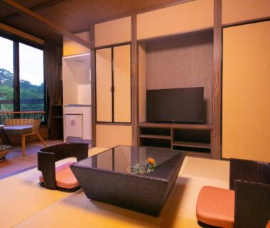 Traditional tatami sitting area with low table and balcony view at Hosenji Kanko Hotel Yumotoya, Oita