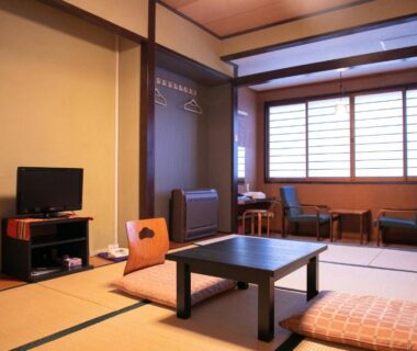 Tatami room with low table and shoji screens at Hosenji Kanko Hotel Yumotoya, Ōita, Kyūshū