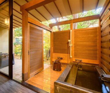 Semi-open wooden soaking tub with sliding screens and garden view at Hoshi in Ishikawa Chūbu