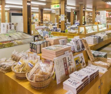 Gift shop interior at Hoshi ryokan in Ishikawa with packaged snacks and souvenirs on wooden displays