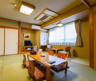 Traditional tatami room with low table, zabuton seating and sliding doors at Hoshikawakan in Nagano, Chūbu
