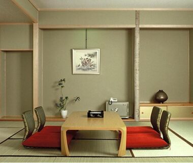 Tatami room with low wooden table, cushions, shoji screens and tokonoma alcove at Hoshikawakan in Nagano