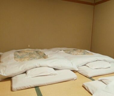 Futon bedding arranged on tatami mats in a simple ryokan room at Hoshikawakan Nagano