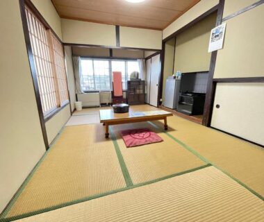 Tatami room with low table and shoji screens at Hot Spring Inn Hyoutan in Gunma