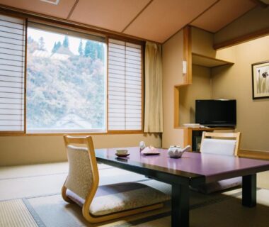 Tatami mat room with low table and zabuton at Hot spring inn Snow country, Niigata