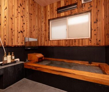 Wood-paneled bathing room with wooden tub at Hotaru no Yado Sendou, Oita Kyushu