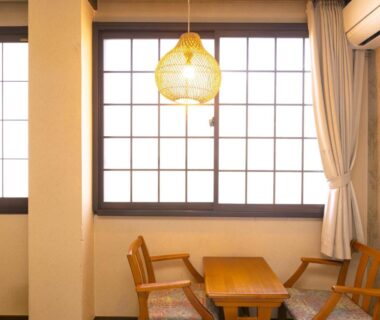 Wooden table and chairs by shoji window in Hotaru no Yado Sendou room, Oita, Kyushu