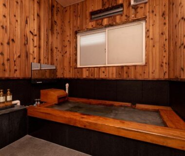 Indoor wood-lined bath with small window at Hotaru no Yado Sendou in Oita, Kyushu