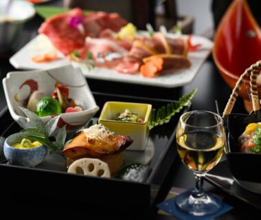 Assorted Japanese dishes on lacquer trays with a glass of wine at Hotel Asyl Nara, Nara, Kansai