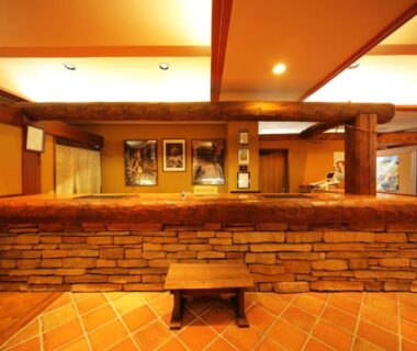 Stone-faced reception counter and bench in warm-lit lobby at Hotel Asyl Nara, Nara, Kansai Japan