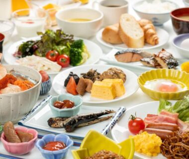Assorted Japanese breakfast dishes including grilled fish tamagoyaki salads and bread at Hotel Daiheigen Hokkaidō Japan
