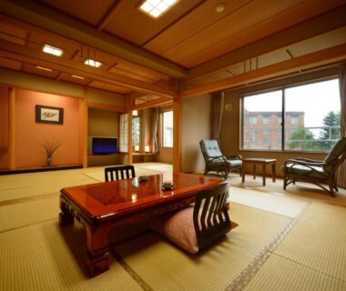 Tatami room with low wooden table and window seating at Hotel Daiheigen, Hokkaidō, Japan