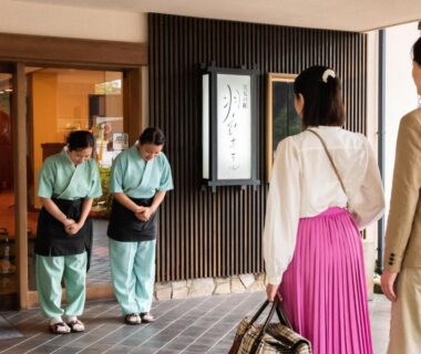 Couple greeted at entrance by bowing staff at Hotel Hagoromo, Shizuoka