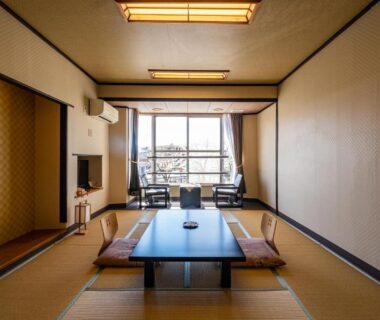 Traditional tatami room with low table and floor cushions at Hotel Hatta in Yamanashi, Chūbu region