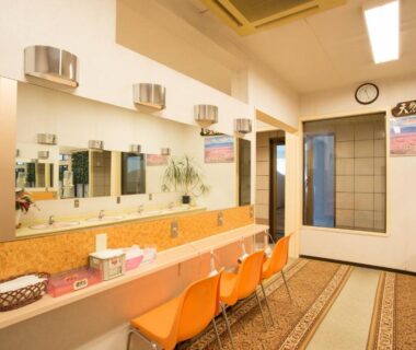 Long vanity and mirrors with orange stools at Hotel Heian Yamanashi Chūbu Japan