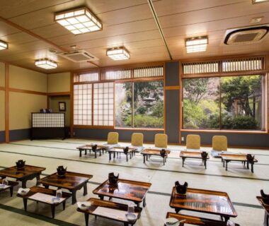 Spacious tatami dining room with low wooden tables and shoji screens at Hotel Heian in Yamanashi, Chūbu, Japan