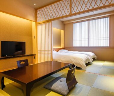 Tatami flooring, low table, shoji screens and twin beds in Hotel Honnoji room, Kyoto Kansai