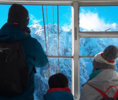 Passengers in cable car viewing snowy peaks near Hotel Hotaka in Chubu, Gifu, Japan