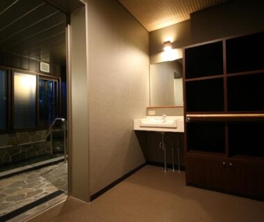 Tiled indoor bath with sink and wooden shelving at Hotel Housei, Nagano, Chūbu Japan