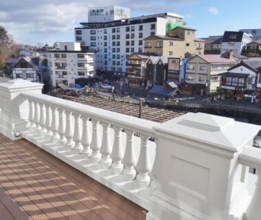 White balustrade terrace overlooking riverside townscape at Hotel Ichii in Gunma, Kantō, Japan