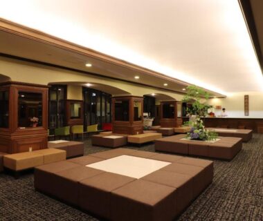 Carpeted lounge with low cushioned platforms and wooden partitions at Hotel Ichii in Gunma, Kantō, Japan